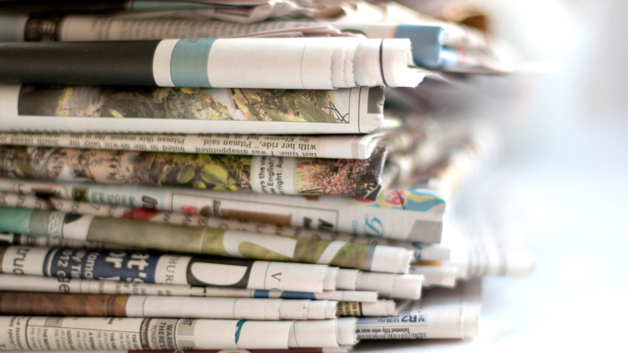 Photo showing a stack of newspapers.